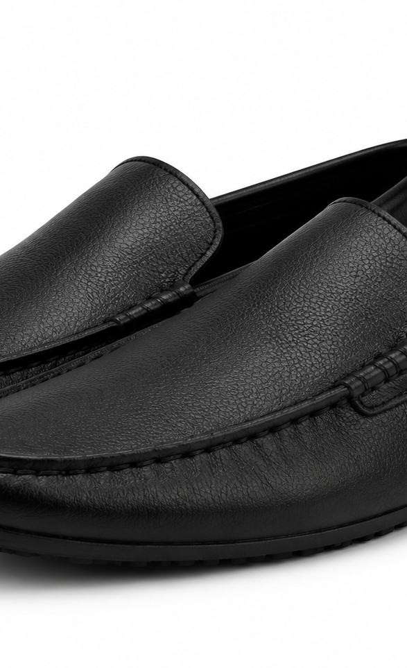 Pair of black leather loafers on a white background