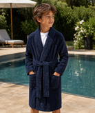 boy wearing Terry Robe near a pool