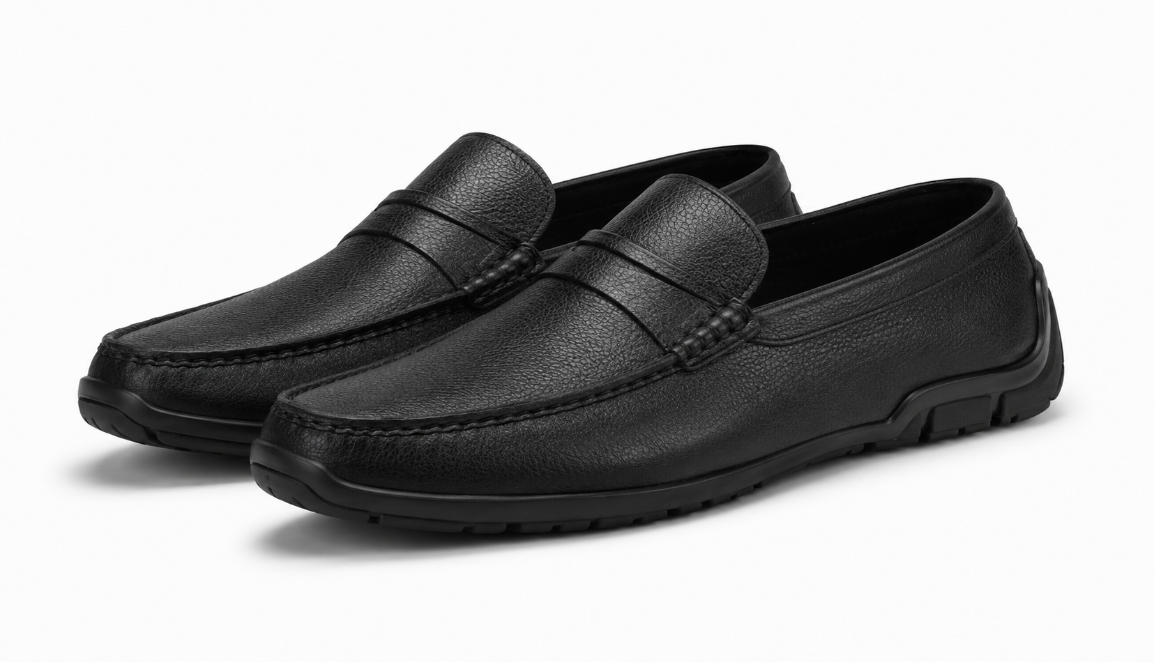 Pair of black leather loafers on a white background