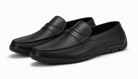 Pair of black leather loafers on a white background