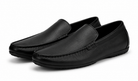 Pair of black leather loafers on a white background